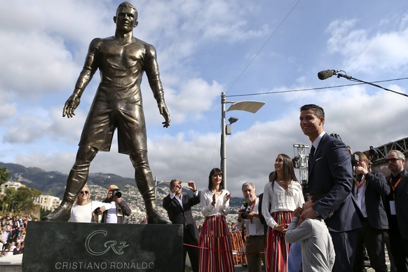 epa04536874 Portuguese soccer player Cristiano Ronaldo from Real Madrid poses during the unveling ceremony of a statue of himself in his hometown of Funchal, Madeira Island, 21 December 2014. EPA/JOSE ...