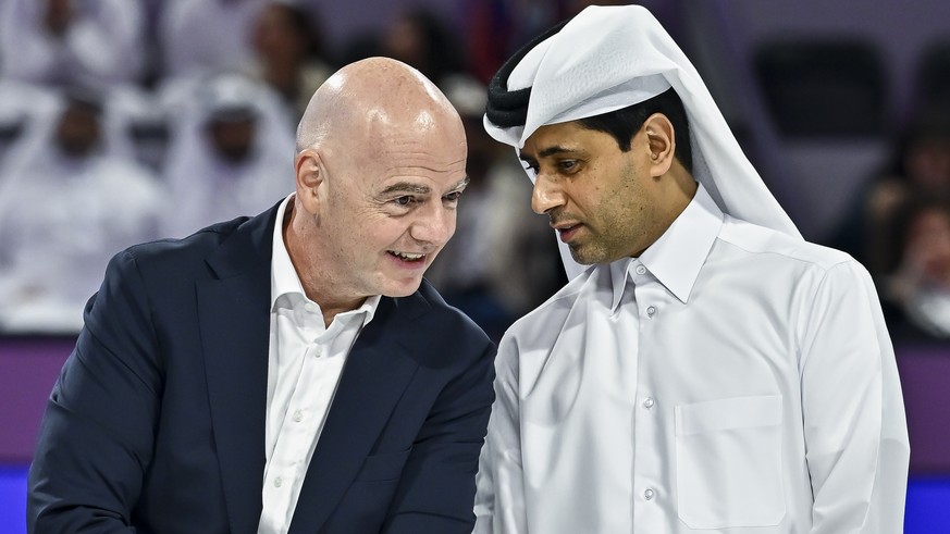 epa12740488 International Association Football Federation (FIFA) President Gianni Infantino (L) and French football club Paris Saint-Germain's Qatari president Nasser al-Khelaifi speak as they wa ...