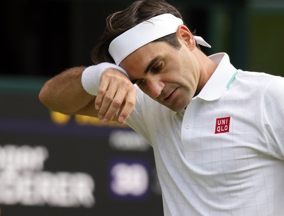 FILE - In this July 7, 2021, file photo, Switzerland&#039;s Roger Federer wipes his brow during the men&#039;s singles quarterfinals match against Poland&#039;s Hubert Hurkacz on day nine of the Wimbl ...