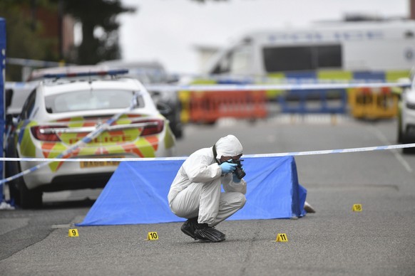A police forensics officer taking photographs in Irving Street, in Birmingham after a number of people were stabbed in the city centre, Sunday, Sept. 6, 2020. British police say that multiple people h ...