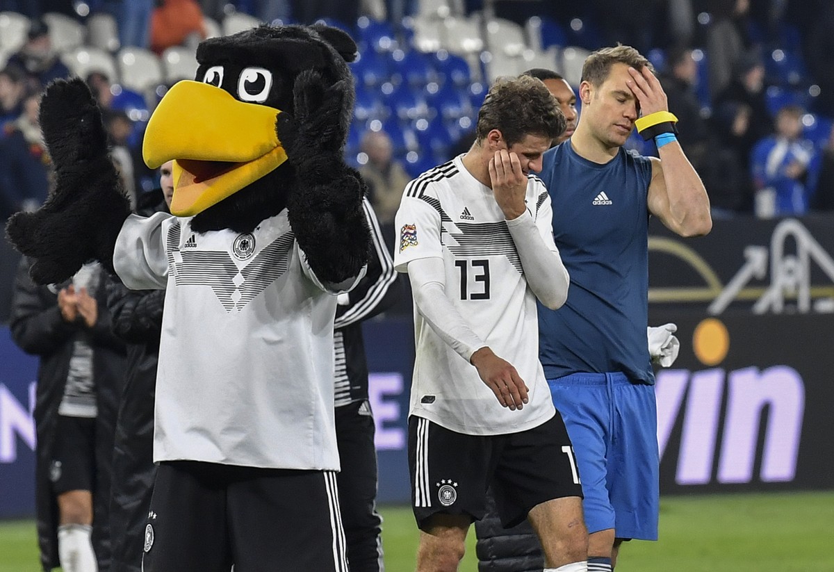 Germany's keeper Manuel Neuer and Thomas Mueller leave the pitch beside the mascot disappointed after the UEFA Nations League soccer match between Germany and The Netherlands in Gelsenkirchen, Mo ...