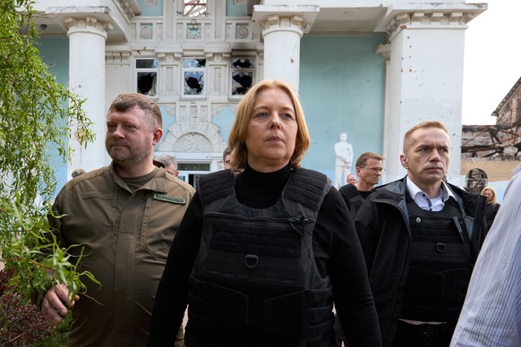 epa09934328 German Parliament &#039;Bundestag&#039; President Baerbel Bas and first deputy chairman of Ukrainian Parliament Oleksandr Kornienko inspect destroyed house of culture during a visit to the ...