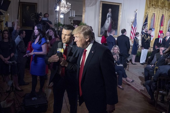 File - President Donald Trump appears on Fox &amp; Friends co-host Pete Hegseth at a Wounded Warrior Project Soldier Ride event in the East Room of the White House in Washington, Thursday, April 6, 20 ...