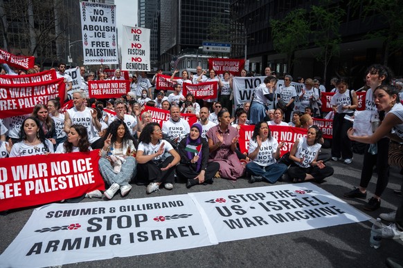 epa12887937 Activists with Jewish Voice (JVP) for Peace and If Not Now When (INNW) block a roadway during a protest against the war in the Middle East, outside of the offices of US Senator Charles Sch ...