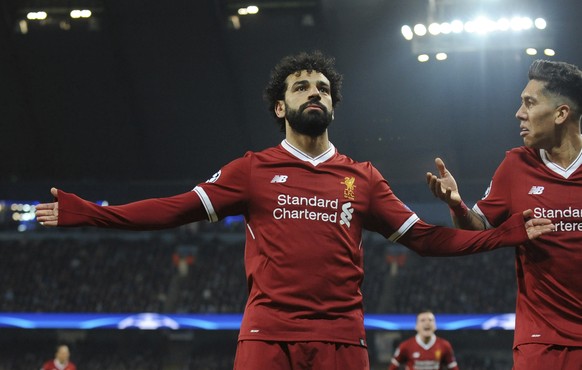 Liverpool&#039;s Mohamed Salah, left, celebrates scoring his side&#039;s first goal with Liverpool&#039;s Roberto Firmino during the Champions League quarterfinal second leg soccer match between Manch ...