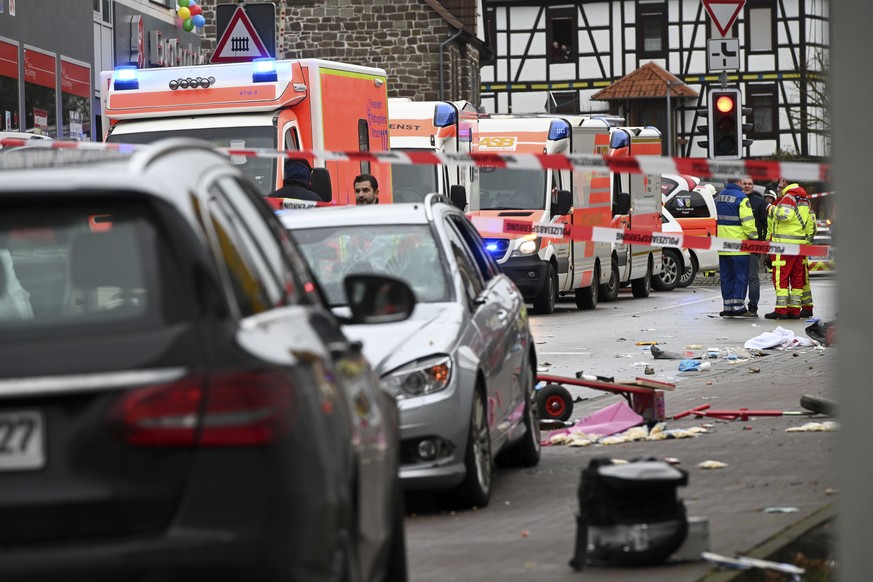 Emergency cars stand next to the scene of the accident with a car that is said to have crashed into a carnival parade in Volkmarsen, central Germany, Monday, Feb. 24, 2020. Several people have been in ...