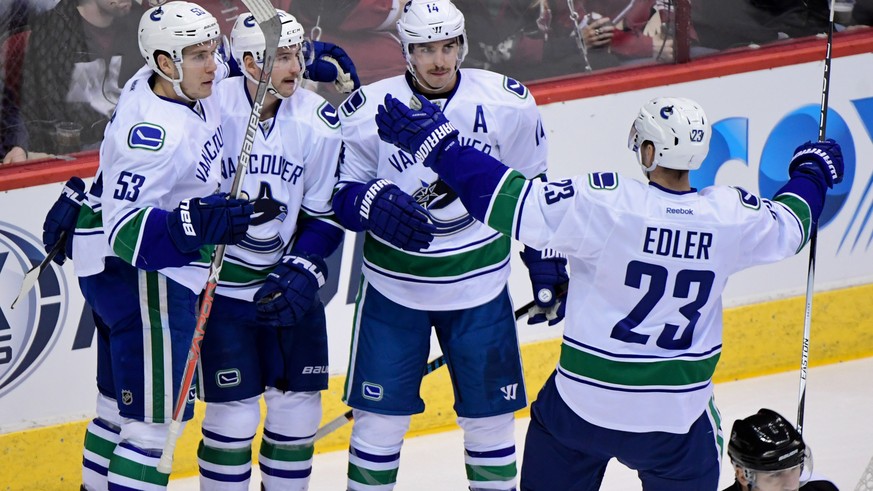 Nov 23, 2016; Glendale, AZ, USA; Vancouver Canucks left wing Sven Baertschi (47) celebrates with defenseman Alexander Edler (23) center Bo Horvat (53) and left wing Alex Burrows (14) after scoring a g ...