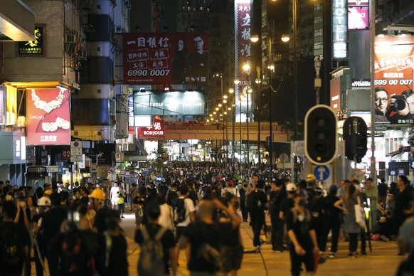 Protestors gather along a street in the Mong Kok neighborhood during a demonstration in Hong Kong, Saturday, Aug. 3, 2019. Hong Kong protesters removed a Chinese national flag from its pole and flung  ...
