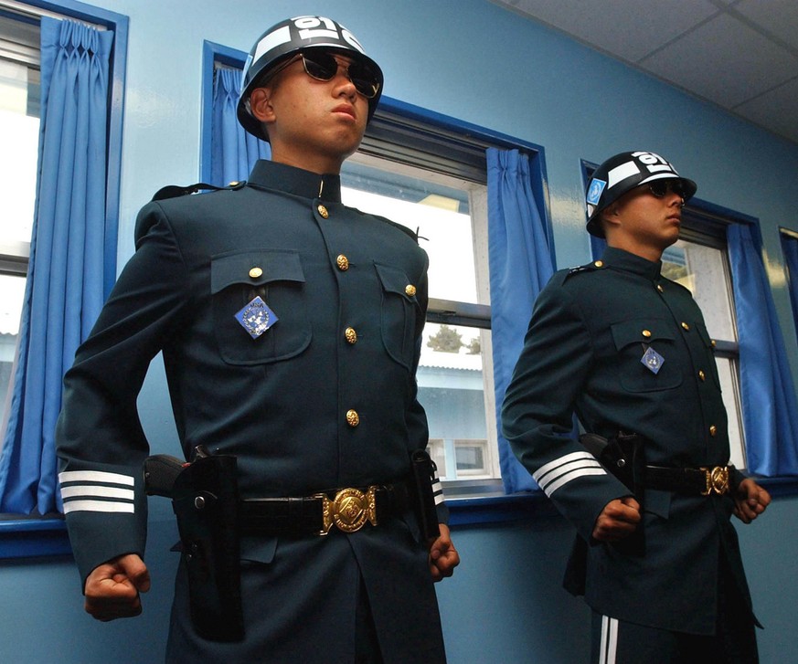 South Korean soldiers stand guard in the military armistice meeting room at the truce village of Panmunjom in the demilitarized zone that separates the two Koreas since the Korean War, north of Seoul, ...