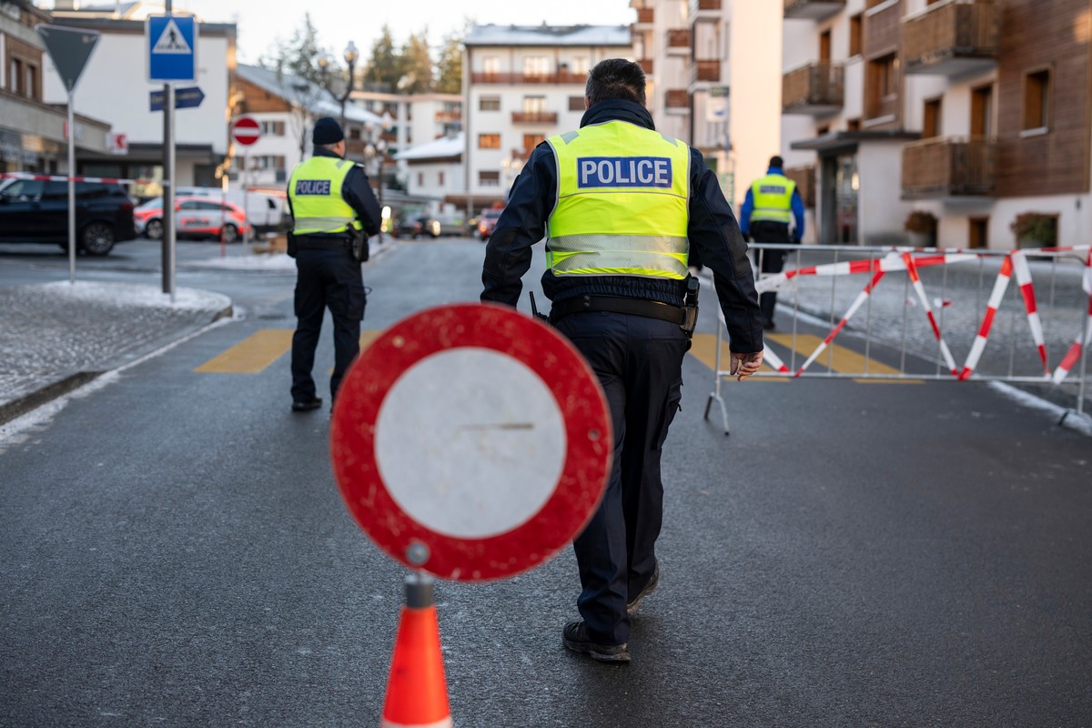 Police officers inspect the area where a fire broke out at the Le Constellation bar and lounge leaving people dead and injured, during New Years celebration, in Crans-Montana, Swiss Alps, Switzerland ...