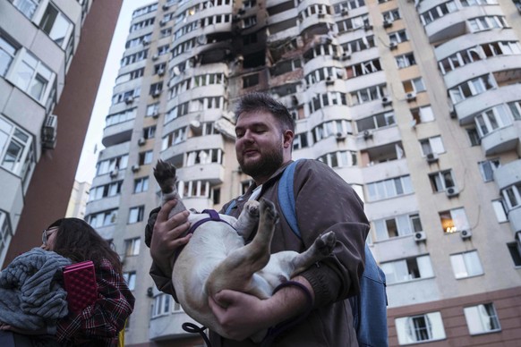 A man carries his dog in front of a residential multi-storey building damaged after a Russian drone strike on Kyiv, Ukraine, on Friday, June 6, 2025. (AP Photo/Evgeniy Maloletka)
Russia Ukraine War
