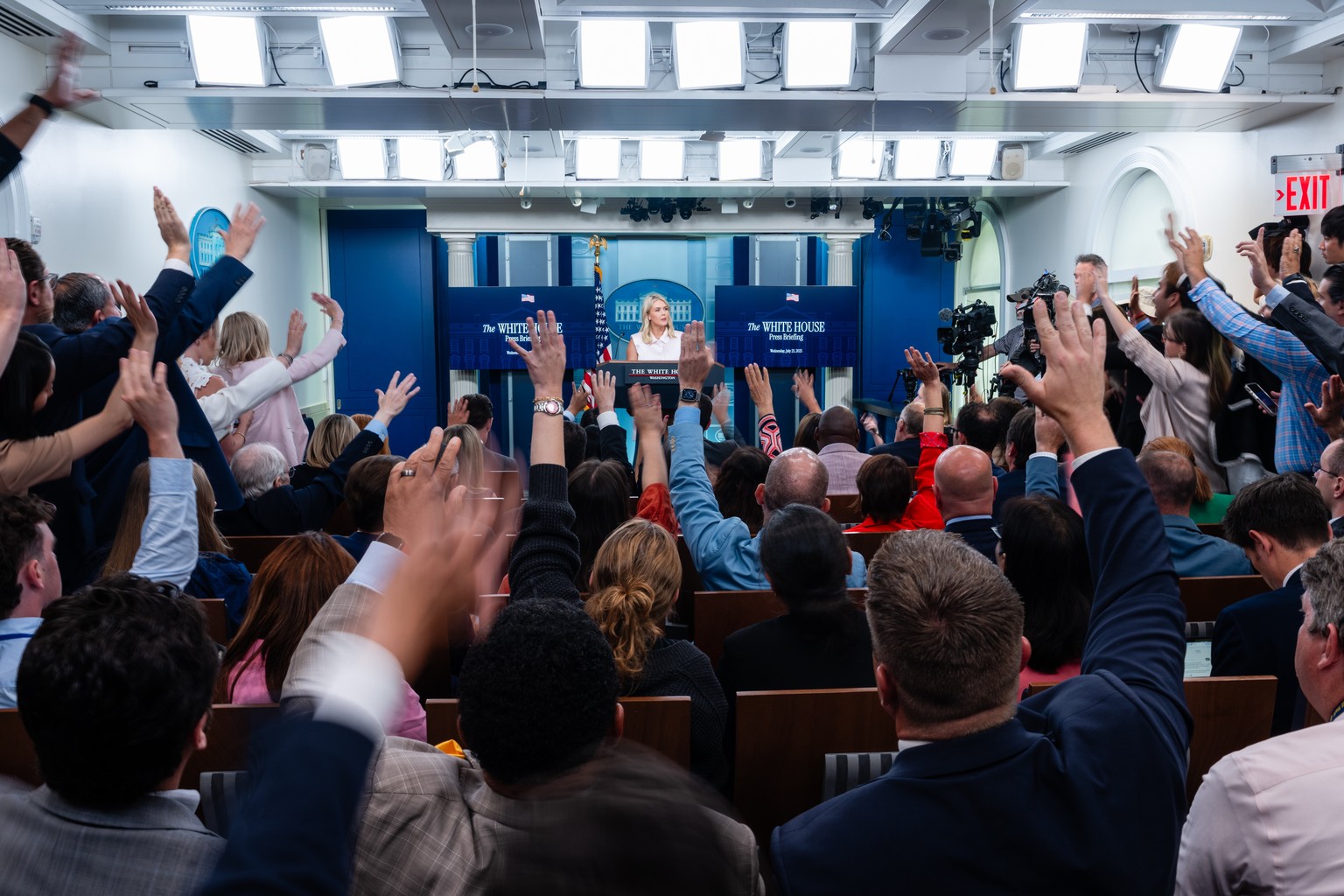 epa12256726 Members of the media raise their hands as White House press secretary Karoline Leavitt (R) speaks during a news conference in the James S. Brady Press Briefing Room of the White House in W ...