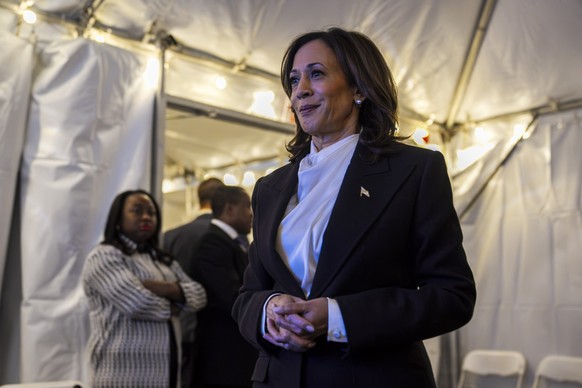 Democratic presidential nominee Vice President Kamala Harris smiles as she looks at a screen of the crowd and layout as she prepares to walk onstage for her speech, during a campaign rally at the elli ...