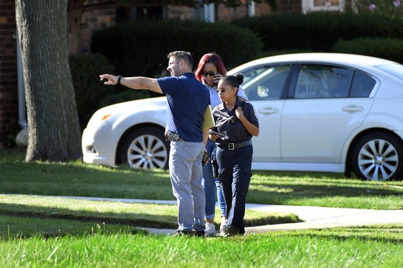 Detroit Police and investigators look over a shooting scene on Pennington Drive, north of Seven Mile Road, Sunday, Aug. 28, 2022, in Detroit. Four people were shot, with fatalities, by a person who ap ...