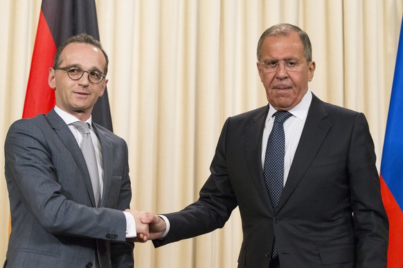 Russian Foreign Minister Sergey Lavrov, right, shakes hands with German Foreign Minister Heiko Maas after their joint news conference following the talks in Moscow, Russia, Thursday, May 10, 2018. (AP ...