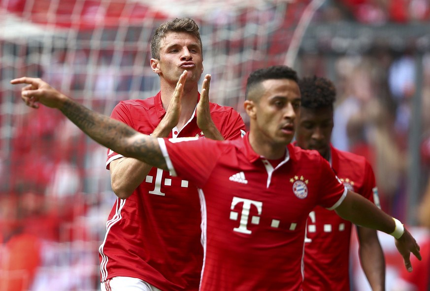 Football Soccer - Bayern Munich v Augsburg - German Bundesliga - Allianz Arena, Munich, Germany - 01/04/17 - Bayern Munich&#039;s Thomas Mueller celebrates with his teammate Thiago after scoring a goa ...