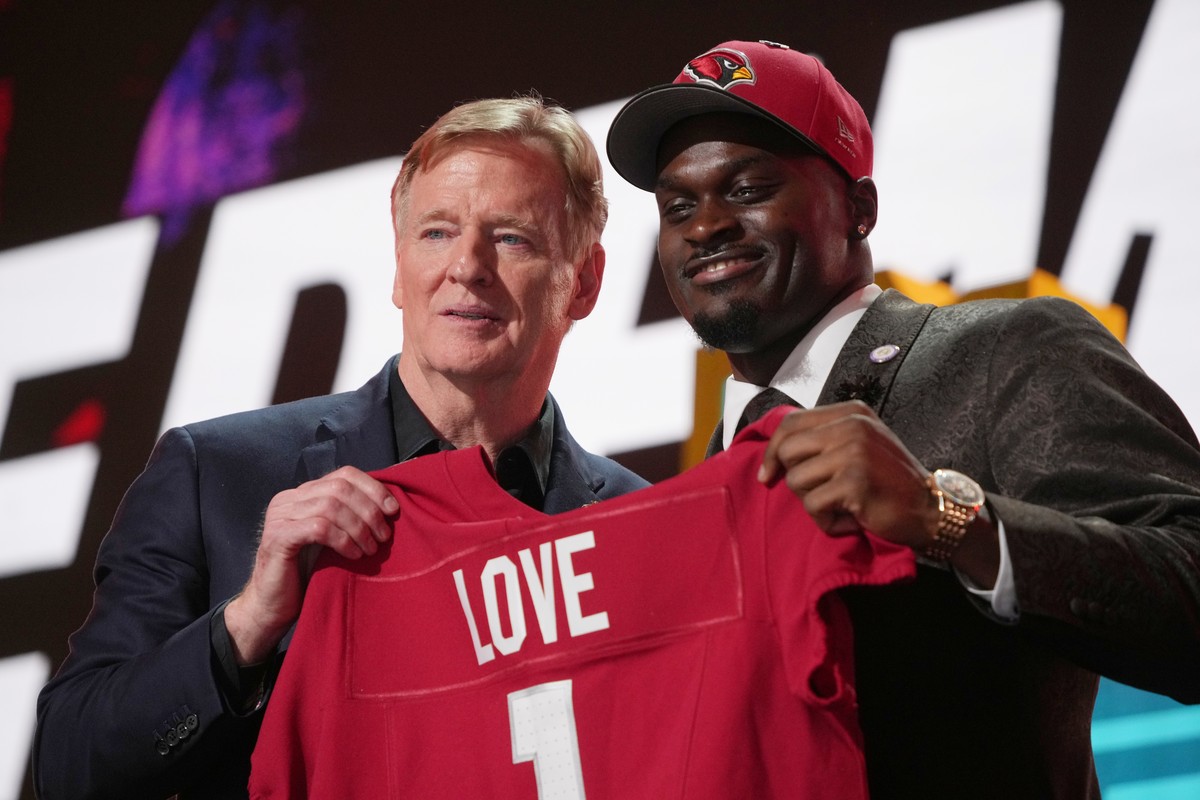 Notre Dame running back Jeremiyah Love, right, poses with NFL Commissioner Roger Goodell after being chosen by the Arizona Cardinals with the third overall pick during the first round of the NFL footb ...