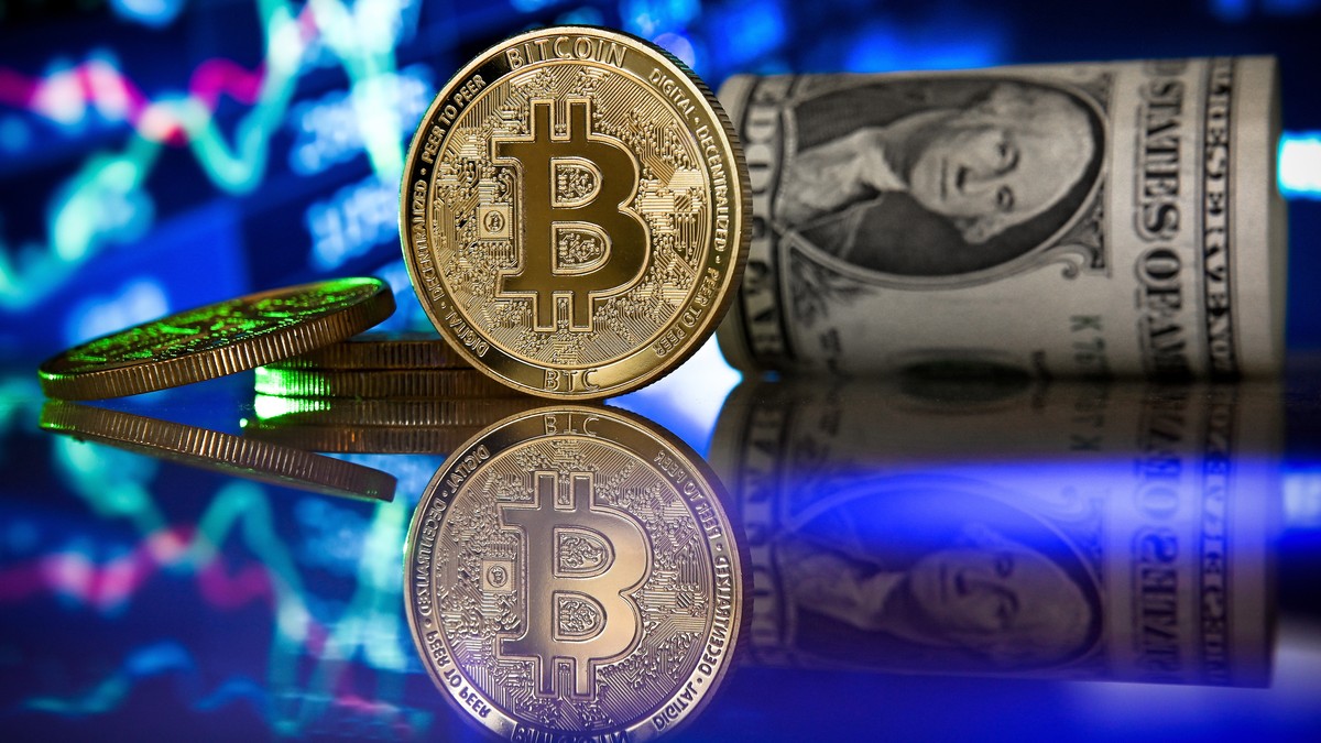 epa09017765 (FILE) - A bitcoin in front of a monitor showing a stock barometer in Duesseldorf, Germany, 20 January 2021 (reissued 17 February 2021). Cryptocurrency Bitcoin's value value crossed t ...
