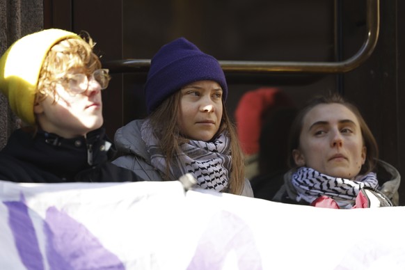 Climate activist Greta Thunberg, centre, and other protesters block the entrance of the Swedish Parliament during a climate protest in Stockholm, Sweden, Monday, March 11, 2024. (Christine Olsson/TT N ...