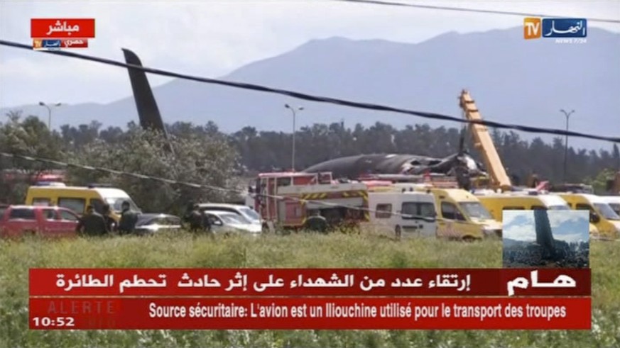 In this still taken from TV showing emergency services at the scene after a military plane crashed soon after takeoff at Boufarik military base, Algeria, Wednesday April 11, 2018. At least 100 people  ...