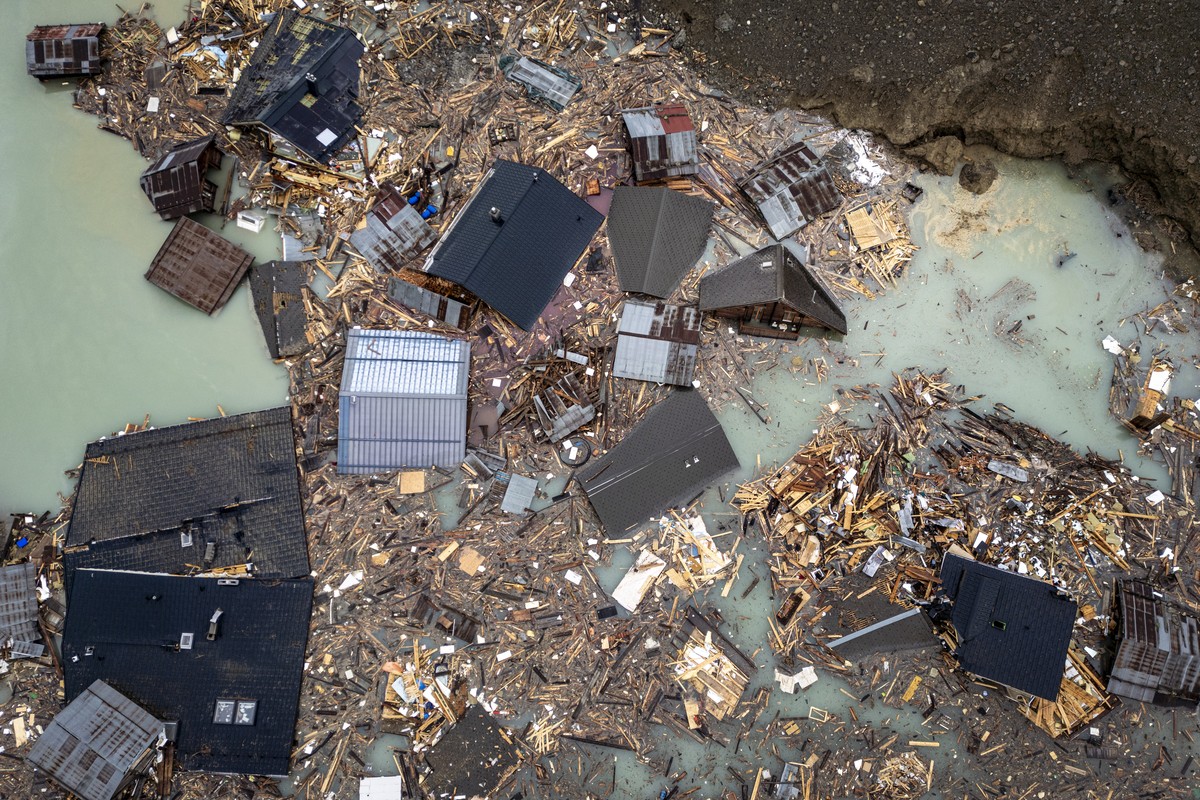 An aerial view shows destroyed houses in the water from the river Lonza that formed a lake beside the massive avalanche, triggered by the collapse of the Birch Glacier, swept down to the valley floor  ...