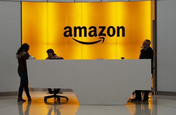 FILE - In this Thursday, Feb. 14, 2019 file photo, People stand in the lobby for Amazon offices in New York. Some Democratic members of Congress and national union leaders have gathered, seeking to bu ...