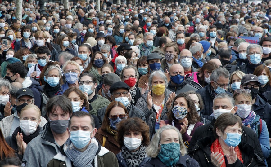 People gather on Republique square during a demonstration Sunday Oct. 18, 2020 in Paris. Demonstrations around France have been called in support of freedom of speech and to pay tribute to a French hi ...