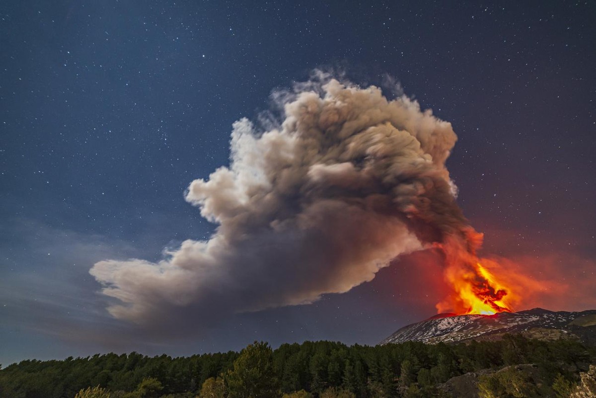 Smoke billows from the Mt. Etna volcano, as seen from Nicolosi, Sicily, southern Italy, Thursday, Feb. 10 , 2022. (AP Photo/Salvatore Allegra)