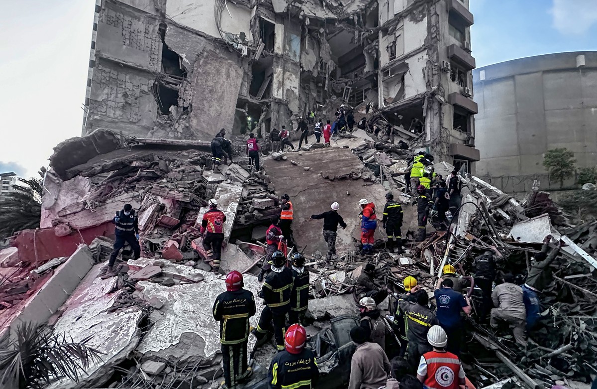 epa12875776 First responders search for missing people under the rubble of a partially destroyed residential building following an Israeli air strike, in the Tallet al-Khayat neighborhood of Beirut, L ...