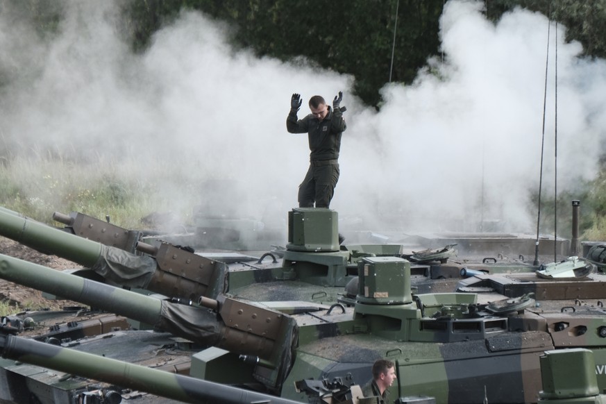 epa09418398 French soldier of NATO Enhanced Forward Presence battlegroup in Estonia with French Army battle tanks Leclerc during training exercise in Adazi Military Base, Latvia, 17 August 2021. EPA/V ...