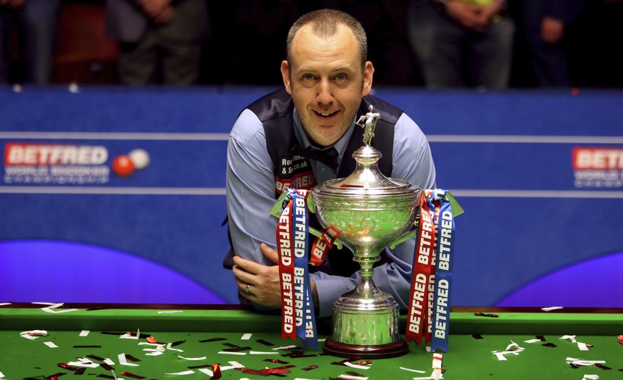 Britain&#039;s Mark Williams poses with the trophy after winning the 2018 Snooker World Championship at The Crucible, Sheffield, England, Monday, May 7, 2018. Mark Williams has won the world snooker c ...