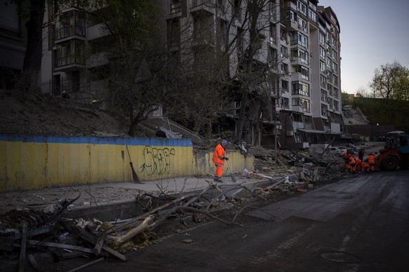 Clean-up crews work at the explosion site in Kyiv, Ukraine on Friday, April 29, 2022. Russia struck the Ukrainian capital of Kyiv shortly after a meeting between President Volodymyr Zelenskyy and U.N. ...