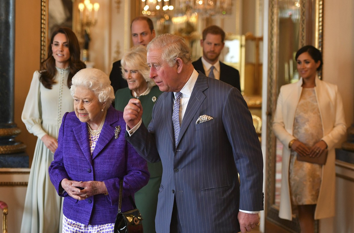 FILE - In this Tuesday, March 5, 2019 file photo, Britain's Queen Elizabeth II is joined by Prince Charles, the Prince of Wales, and at rear, from left, Kate, Duchess of Cambridge, Camilla, Duche ...