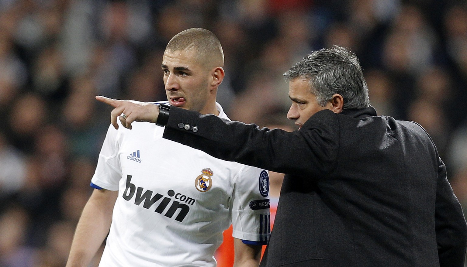 Real Madrid&#039;s coach Jose Mourinho from Portugal, right gives instructions to Karim Benzema from France during a Round of 16, 2nd leg Champions League soccer match against Lyon at the Santiago Ber ...