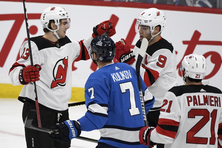 New Jersey Devils&#039; Nico Hischier (13) celebrates his goal against the Winnipeg Jets with teammate Taylor Hall (9) during the first period of an NHL hockey game, Tuesday, Nov. 5, 2019 in Winnipeg, ...
