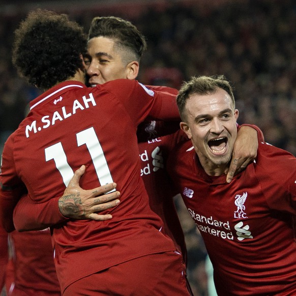 epaselect epa07253405 Liverpool&#039;s Roberto Firmino is congratulated by Mohamed Salah and Xherdan Shaqiri (R) after scoring the sixth goal in the English Premier League soccer match between Liverpo ...