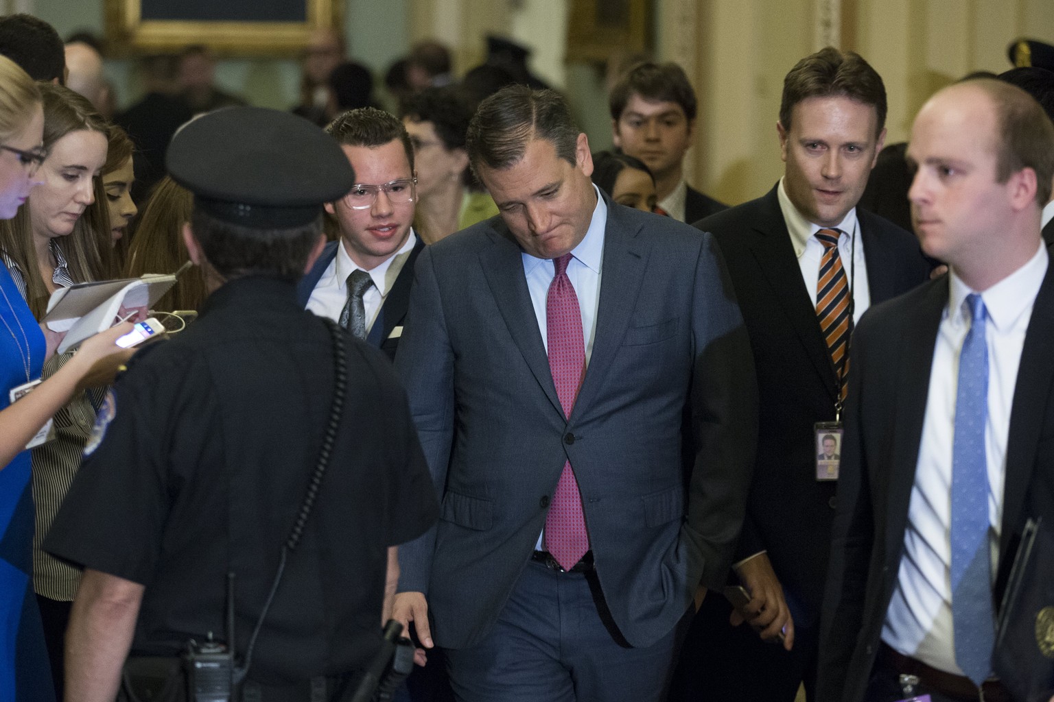 epa06109531 Republican Senator from Texas Ted Cruz (C) walks to the Senate floor before the Senate passed the motion to proceed on President Trump&#039;s effort to repeal and replace Obamacare, in the ...