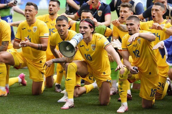 Romania players celebrate their victory at the Group E match between Romania and Ukraine at the Euro 2024 soccer tournament in Munich, Germany, Monday, June 17, 2024. (AP Photo/Matthias Schrader)
