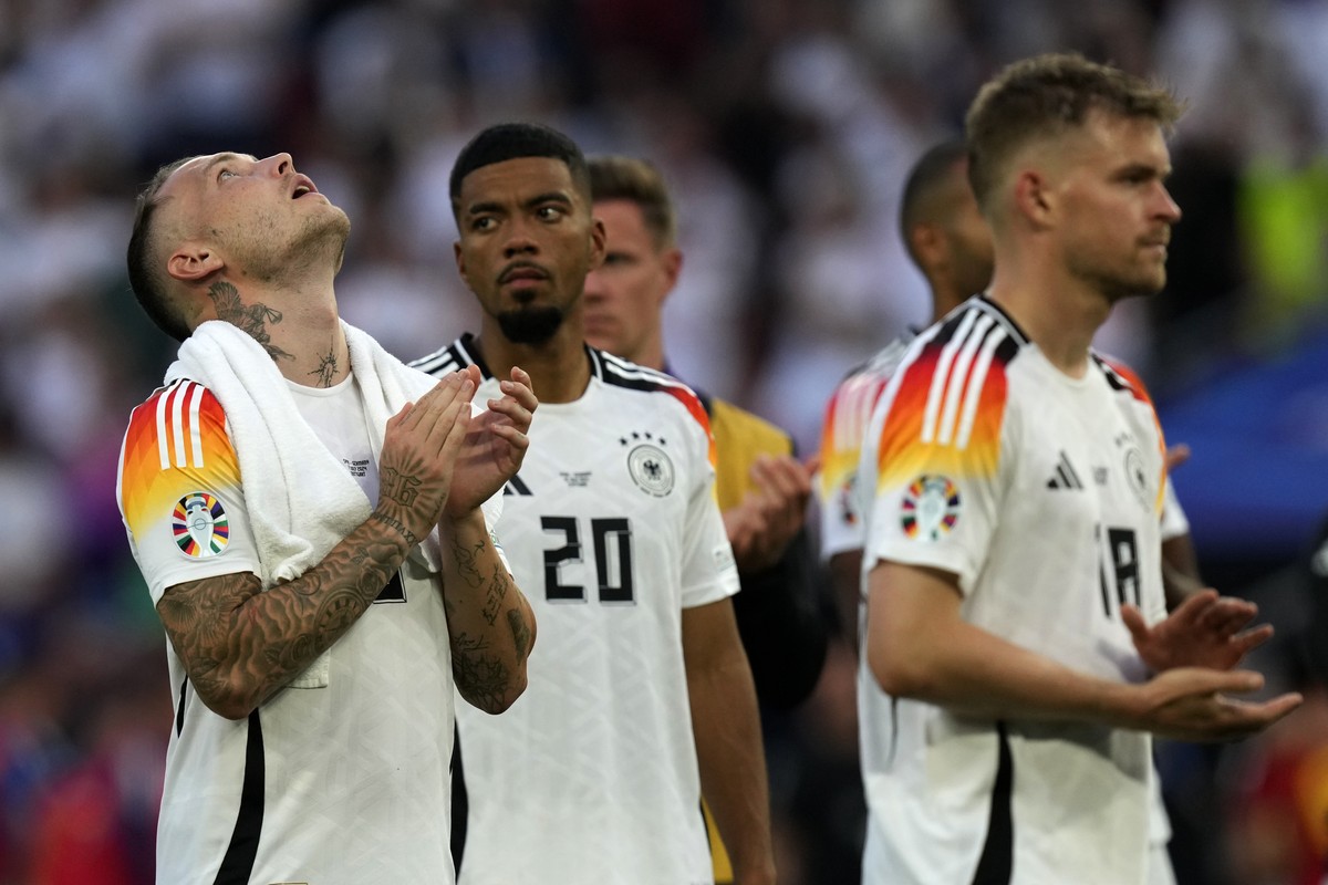 Germany's David Raum, left, with teammates at the end of a quarter final match between Germany and Spain at the Euro 2024 soccer tournament in Stuttgart, Germany, Friday, July 5, 2024. (AP Photo/ ...