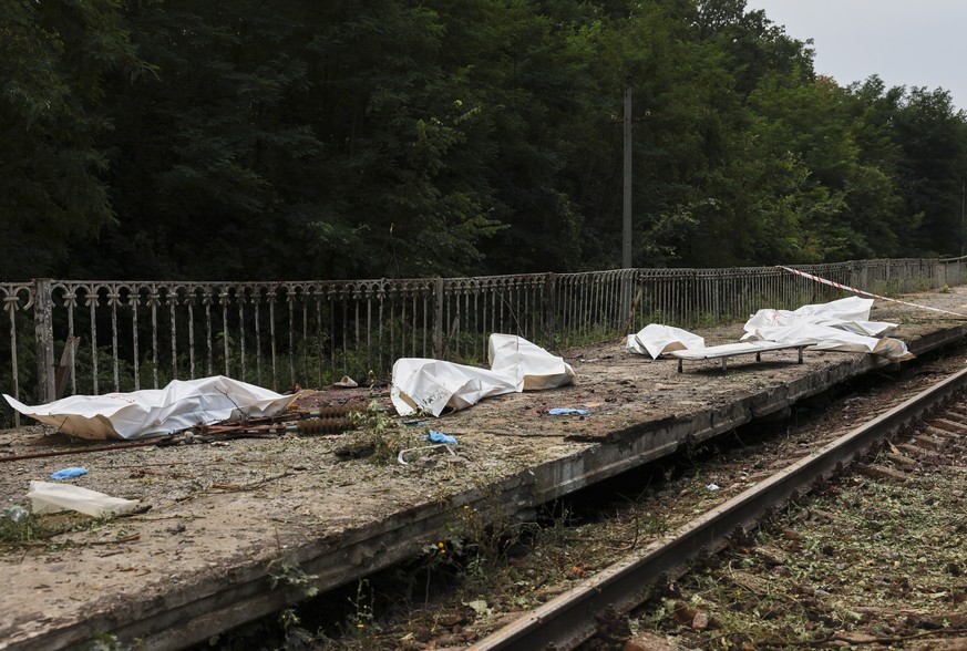 epa13151394 The bodies of victims lay in body bags at the site of a Russian missile strike on a commuter train station near Kyiv, Ukraine, 05 August 2026, amid the Russian invasion. At least 17 people ...