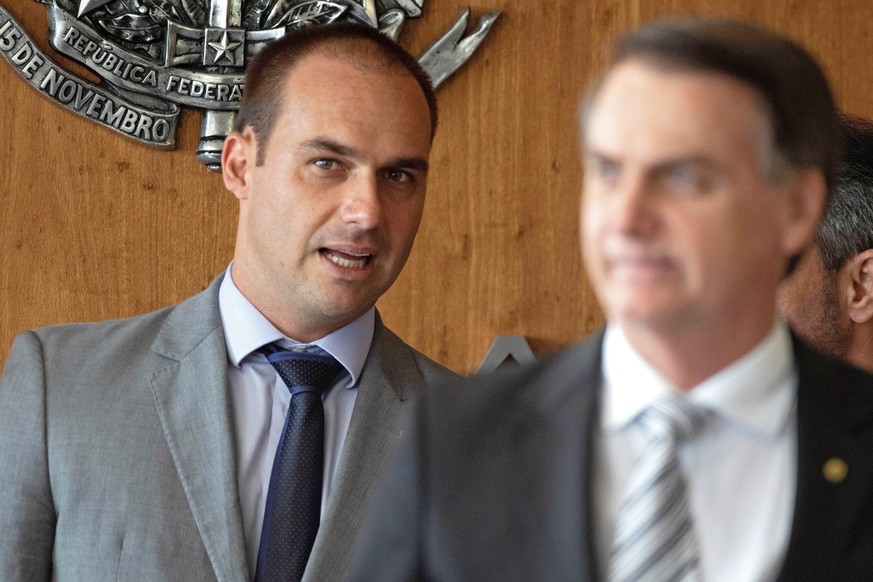 epa07711830 (FILE) - Brazilian President-elect Jair Bolsonaro (R) and his son, congressman Eduardo Bolsonaro (L) arrive at the Supreme Court of Justice for a press conference, in Brasilia, Brazil, 07  ...