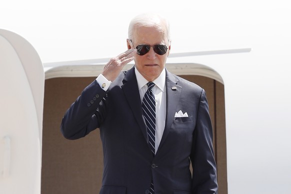 President Joe Biden salutes before boarding Air Force One and departing Andrews Air Force Base, Md., Thursday, Aug. 17, 2023, en route to Pennsylvania and then on to Camp David. (AP Photo/Luis M. Alva ...