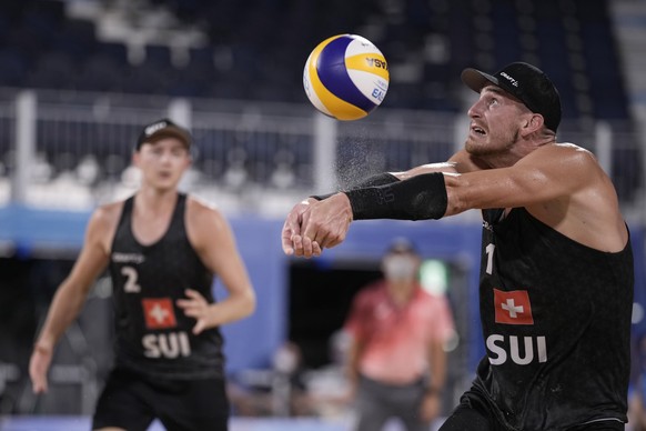 Adrian Heidrich, right, of Switzerland, returns a shot as teammate Micro Gerson watches during a men&#039;s beach volleyball match against Chile at the 2020 Summer Olympics, Saturday, July 31, 2021, i ...