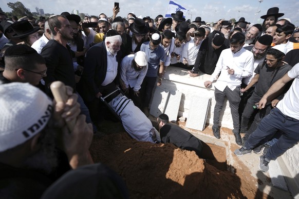 Yonatan Havakuk is buried in Petah Tikva, Israel, the day after he was killed with two others in a stabbing attack in Elad, Friday, May 6, 2022. Israeli security forces waged a massive manhunt Friday  ...