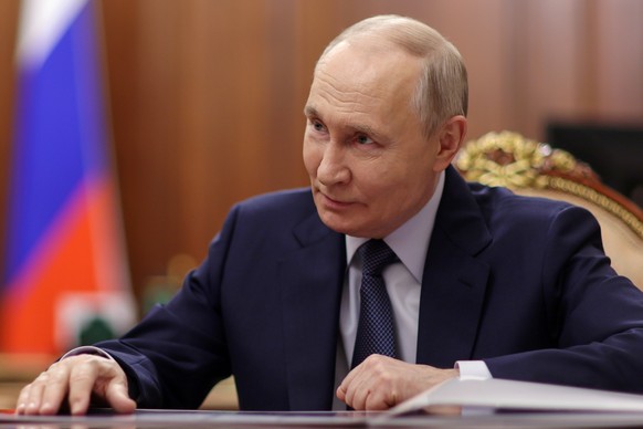 Russian President Vladimir Putin listens to Rashid Temrezov, the head of the Karachay-Cherkess Republic, during their meeting at the Kremlin in Moscow, Thursday, April 16, 2026. (Alexander Kazakov/Spu ...