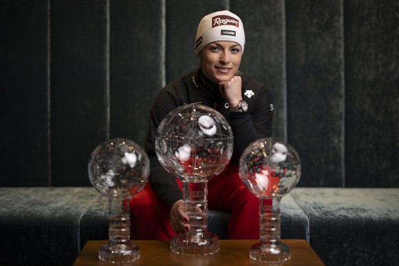 Lara Gut-Behrami poses with her crystal globes for Giant Slalom, Super-G and Overall World Cup, after the women&#039;s downhill race at the FIS Alpine Skiing World Cup finals in Saalbach-Hinterglemm,  ...