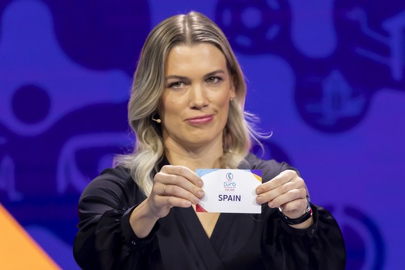 Swiss former player and ambassador for the UEFA Lara Dickenmann shows the ticket of Spain at the UEFA Women&#039;s EURO 2025 final draw, in Lausanne, Switzerland, Monday, December 16, 2024. The UEFA W ...