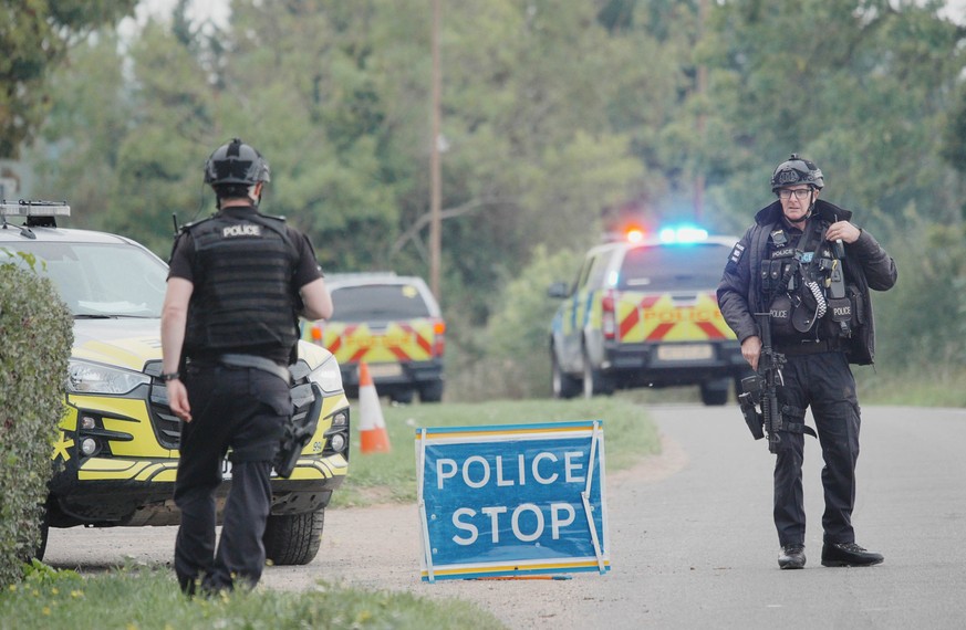 Police stand at a road block on the road to RAF Fairford after an incident, in Whelford, England, Sunday, Sept. 27, 2026 .(Ben Birchall/PA via AP)
Britain Explosives Arrests
