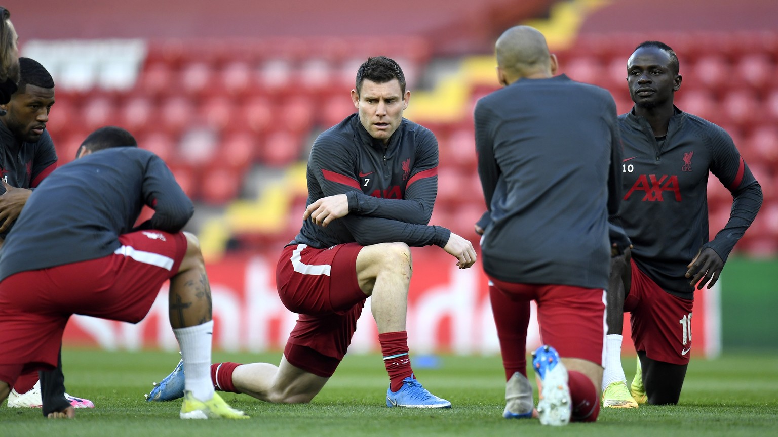 epa09135516 Liverpool players warm up for the UEFA Champions League quarter final, second leg soccer match between Liverpool FC and Real Madrid in Liverpool, Britain, 14 April 2021. EPA/Peter Powell