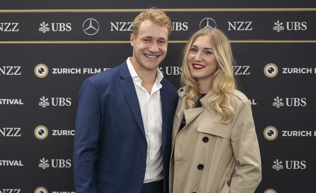 epa11642078 Swiss ski racer Marco Odermatt (L) and Stella Parpan pose on the Green Carpet before the screening of the documentary film 'Aiming High - A Race Against the Limits' at the 20th Z ...
